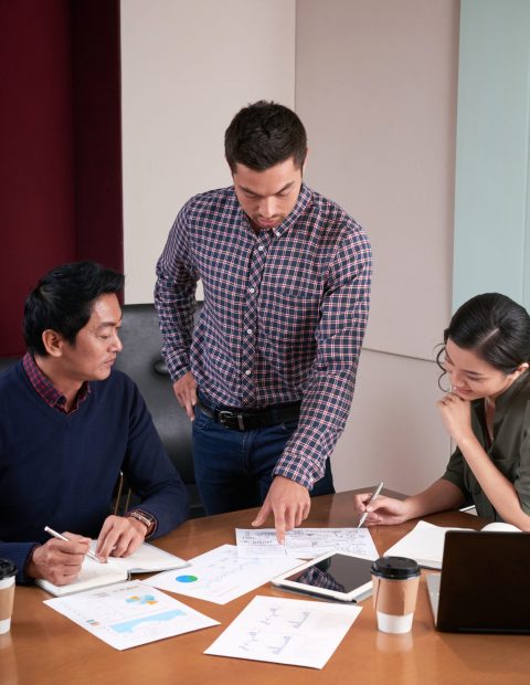 Businessman showing report he made to coworkers